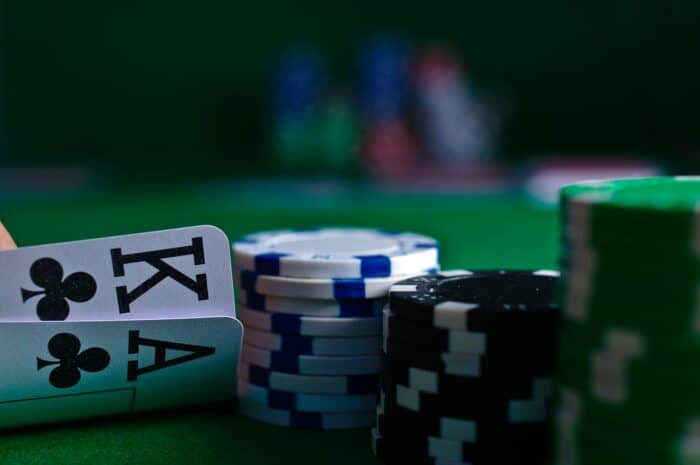 A focused poker player making a decision at the table, illustrating the challenge of LLMs in poker AI.